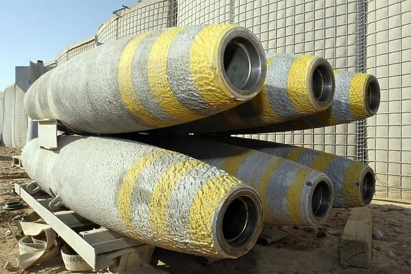 Six GBU-12 bombs sit in a rack inside a weapons storage area