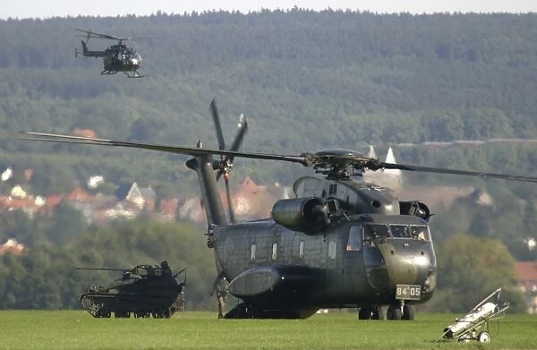 A German CH-53G helicopter unloads a Wiesel armored vehicle