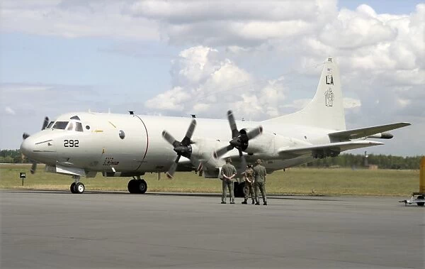 German ground crew members observe a P-3C Orion of the U. S. Navy