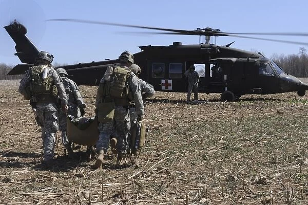 Green Berets move a simulated casualty to a UH-60 helicopter for transport
