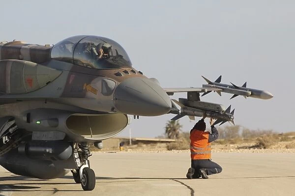 Ground crew member checks the Rafael Python missile on a F-16I Sufa jet