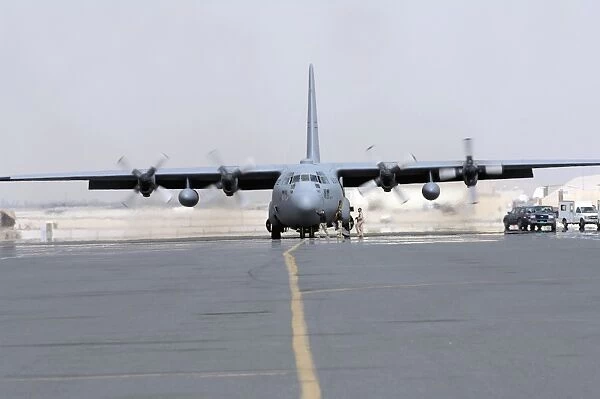 Ground crews prepare a C-130 Hercules for take off