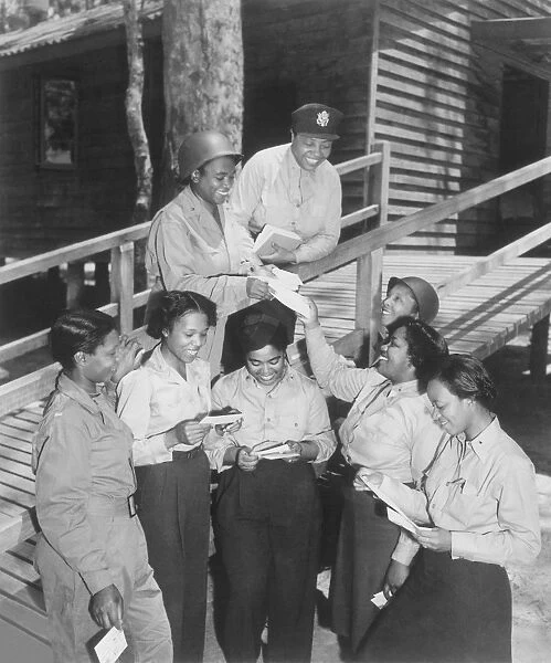 A group of nurses receiving their first batch of mail from home while in Australia