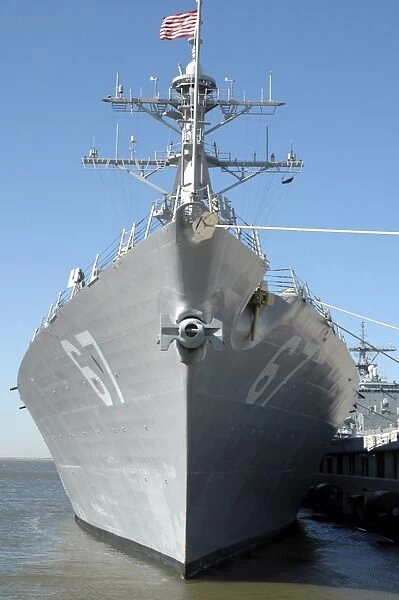 The guided missile destroyer USS Cole sits moored to a pier