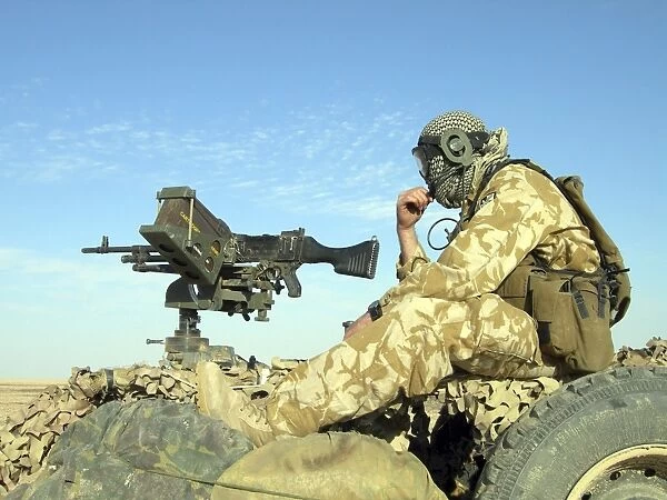 A gunner sits atop a British Army WMIK Land Rover