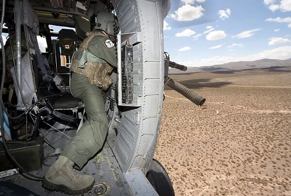 A HH-60G Pave Hawk gunner fires his GAU-17 machine gun