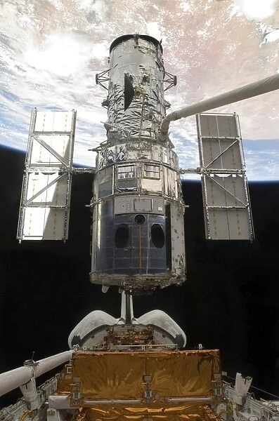 The Hubble Space Telescope is released from the cargo bay of Space Shuttle Atlantis