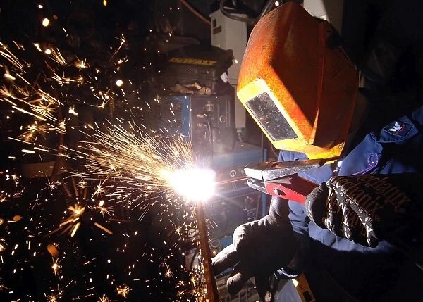 Hull Technician practices cutting metal using a Carbon arc