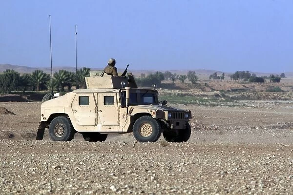 A humvee filled with Marines conducting a mounted combat patrol