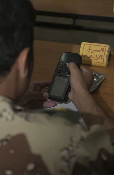 An Iraqi Army lieutenant learns how to use a handheld GPS device