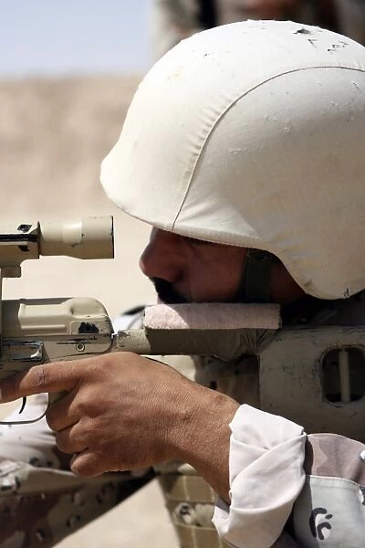 Iraqi Army Sergeant sights in down range during an advanced marksmanship course