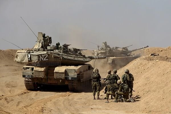 An Israel Defense Force Merkava Mark IV battle tank with infantry forces