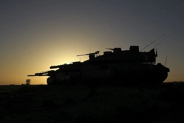 An Israel Defense Force Merkava Mark IV main battle tank at sunset