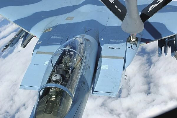 A KC-135 Stratotanker provides in-flight refueling to an F-15 Eagle