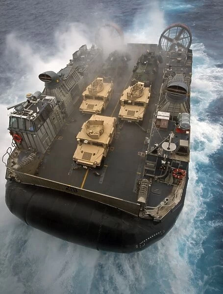 A Landing Craft Air Cushion exits the well deck of USS Bonhomme Richard