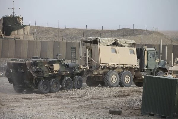 A light armored vehicle being towed at a military base in Afghanistan