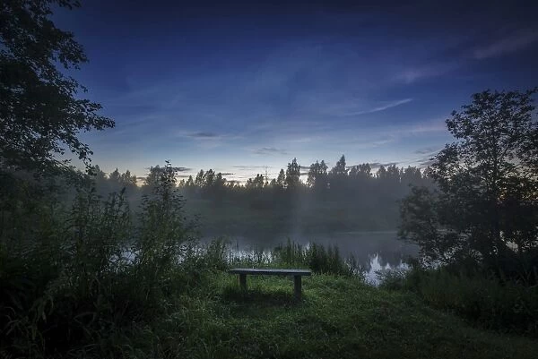 Lonely bench on the bank of the Sestra River in Russia