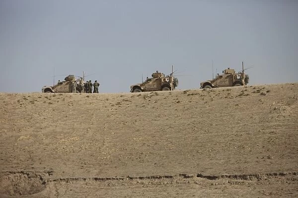 Three M-ATVs guard the top of the wadi near Kunduz, Afghanistan