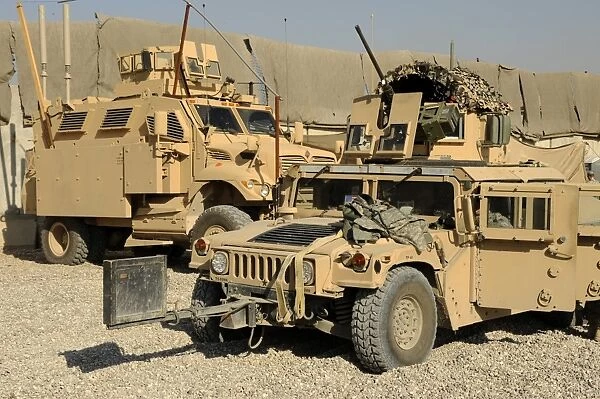 A M1114 humvee sits parked in front of a MaxxPro MRAP
