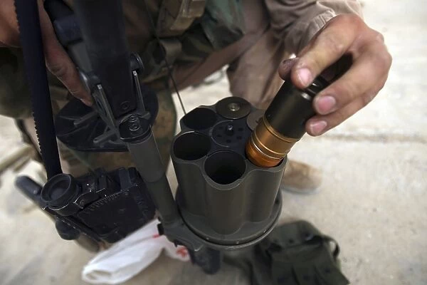 A Marine loads 40 mm grenades