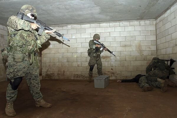 Marines hold an SASO instructor down while checking him to see if he has any hidden