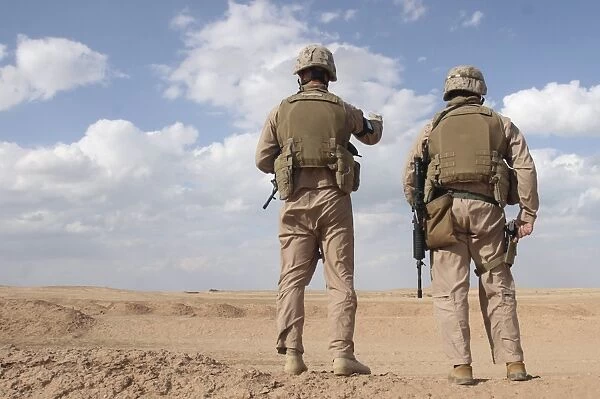 Marines scan the horizon for insurgent activity during a security patrol