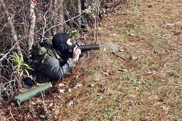 A marksman observer relays intelligence during an exercise
