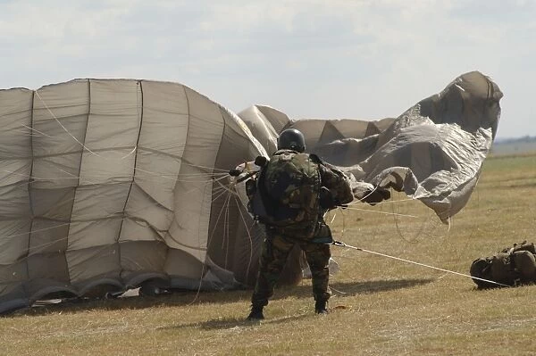 A member of the Pathfinder Platoon collapses his parachute after a HALO jump