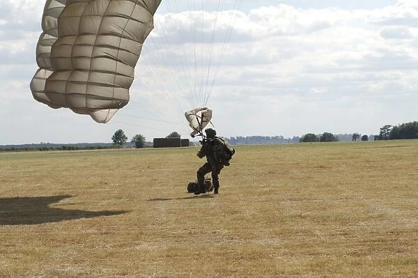 A member of the Pathfinder Platoon collapses his parachute after a HALO jump