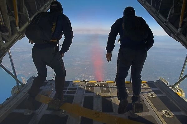 Members of the U. S. Navy Parachute Team Leap Frogs jump above Huntington Beach