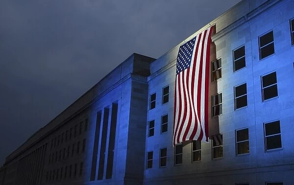 A memorial flag is illuminated on The Pentagon