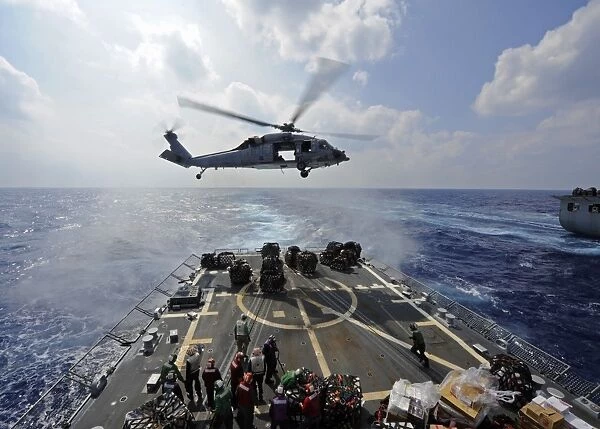 An MH-60R Sea Hawk transfers supplies to the flight deck of USS Wayne E. Meyer