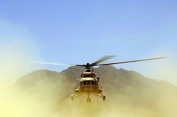 A Mi-17 Hip helicopter hovers over a firing range in Afghanistan