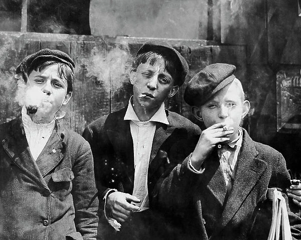 Missouri newsboys smoking on a street in St. Louis, 1910