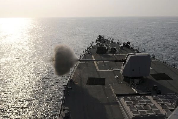 An Mk-45 lightweight gun is fired aboard guided missile destroyer USS Truxtun