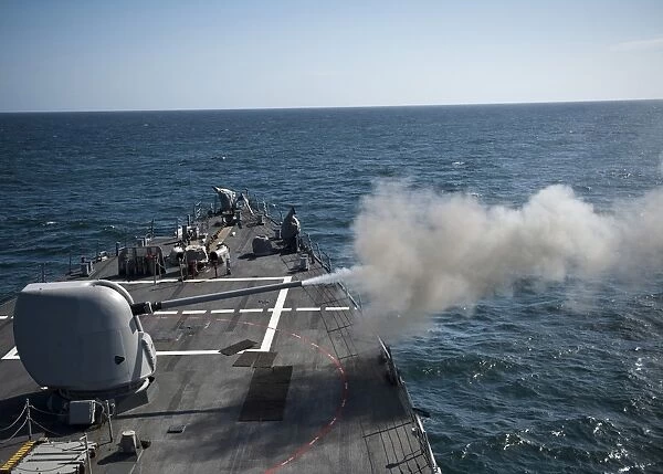 An Mk-45 lightweight gun is fired aboard guided missile destroyer USS Arleigh Burke