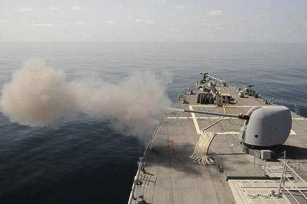 An Mk-45 lightweight gun is fired aboard guided missile destroyer USS Mitscher