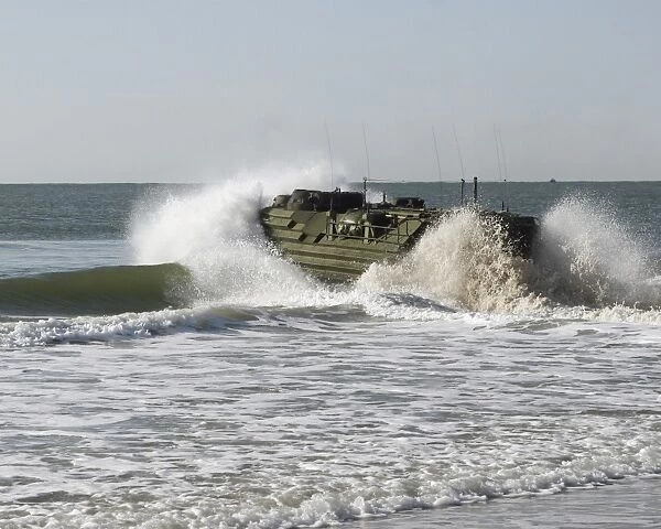 n amphibious assault vehicle splashes through the water
