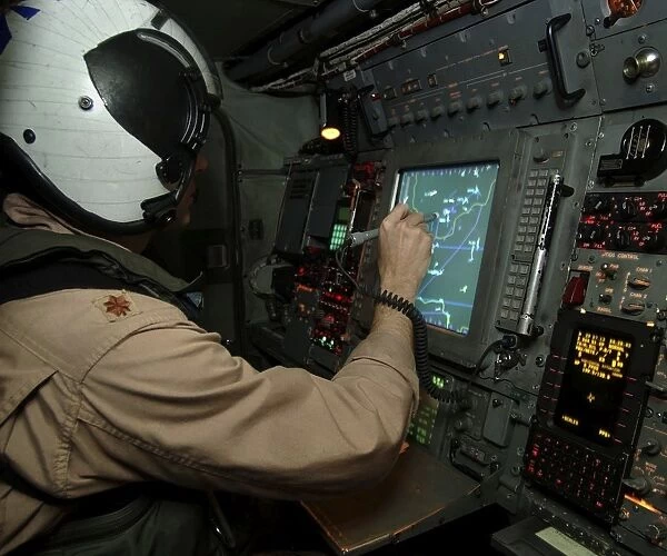 A Naval Flight Officer tracks aircraft at his station on an E-2C Hawkeye