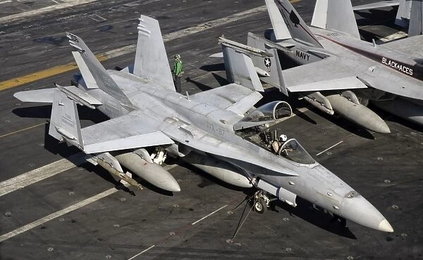 A US Navy F  /  A-18C Hornet parked on the flight deck of USS Nimitz