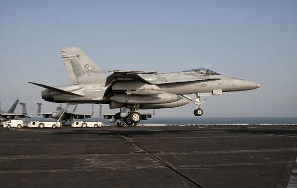 A US Navy F  /  A-18C Hornet prepares to land aboard USS Eisenhower