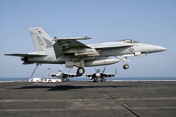 A US Navy F  /  A-18E Super Hornet prepares to land aboard USS Eisenhower