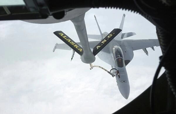A Navy F  /  A-18F Super Hornet is refueled by a KC-135R Stratotanker