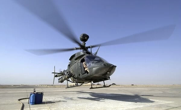 An OH-58D Kiowa Warrior helicopter taking off from Forward Operating Base MacKenzie