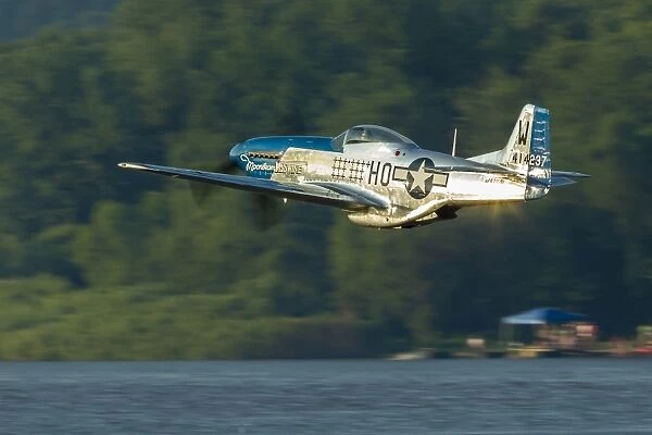 A P-51 Mustang flies along the Mississippi at Dubuque, Iowa