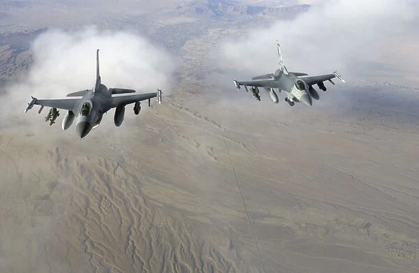 A pair of U. S. Air Force F-16C Fighting Falcons in flight over Afghanistan