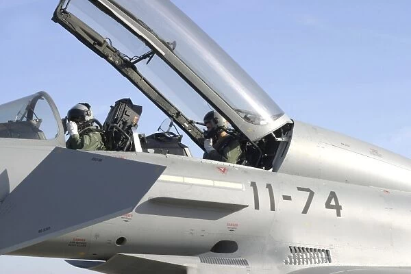 Pilots perform preflight checks in the cockpit of a Eurofighter Typhoon