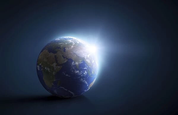 Planet Earth and sunlight on a dark blue background