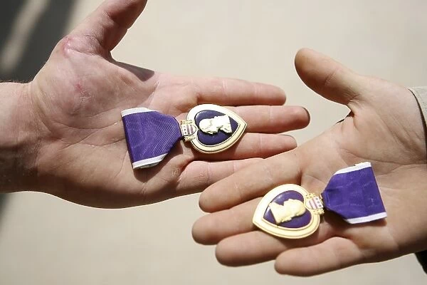 Purple Heart recipients display their medals in their hands