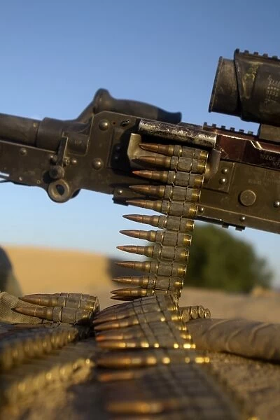 Rounds of a M240 machine gun over a compound roof